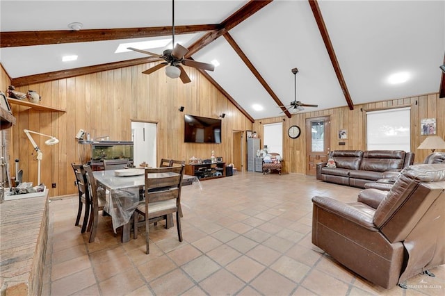 1205 Susan Dr, Edinburg, TX 78539 - dining room with light tile patterned flooring, a ceiling fan, lofted ceiling with beams, and wood walls