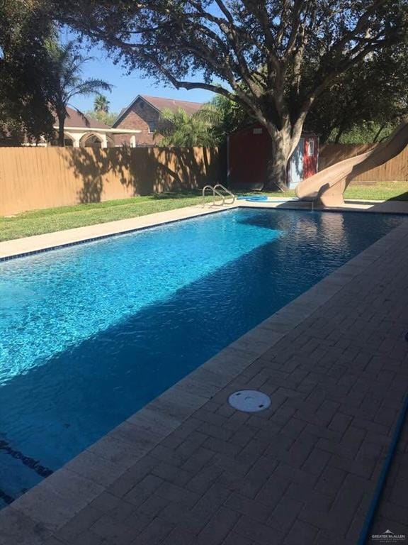1205 Susan Dr, Edinburg, TX 78539 - view of pool featuring a fenced in pool, a water slide, and a fenced backyard