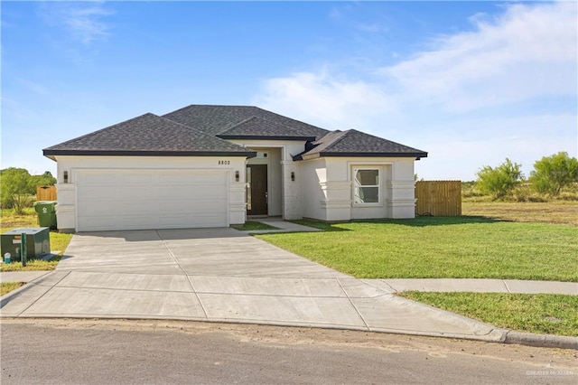 view of front of home featuring a front yard and a garage