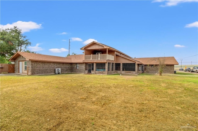 back of property featuring a lawn and a balcony