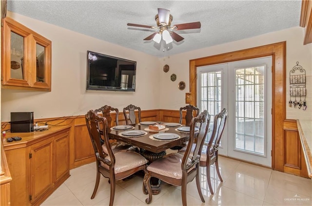 dining space with a textured ceiling, ceiling fan, and light tile patterned flooring