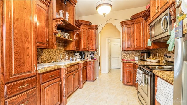 2904 Victoria St, Hidalgo, TX 78557 - kitchen featuring stainless steel appliances, backsplash, light tile patterned flooring, and light stone countertops