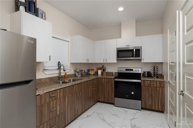 1448 W B St, Mission, TX 78572 - kitchen with stainless steel appliances, light marble finish flooring, white cabinetry, recessed lighting, and light stone counters