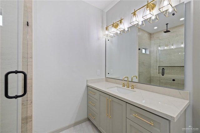 full bath with vanity, baseboards, and a stall shower