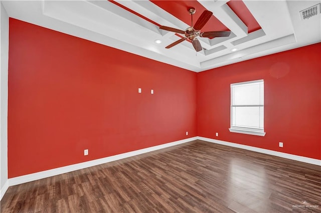 spare room with visible vents, coffered ceiling, wood finished floors, baseboards, and ceiling fan