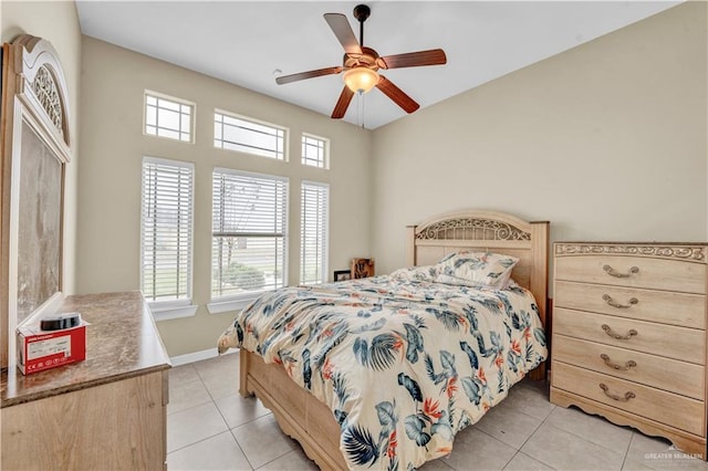 bedroom with light tile patterned floors, baseboards, and ceiling fan