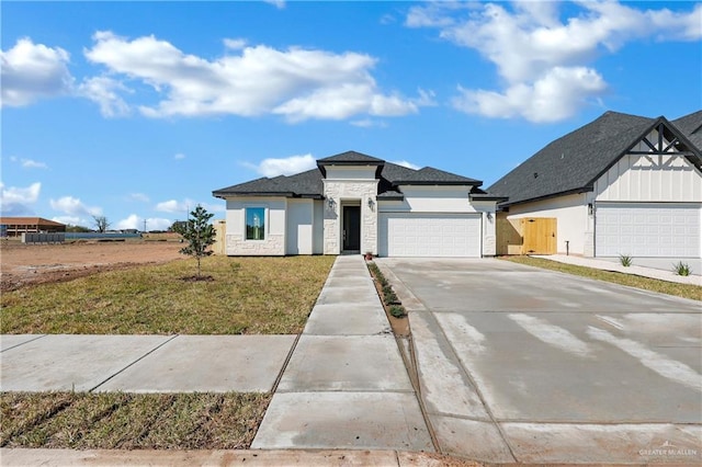 view of front facade with an attached garage, stone siding, driveway, stucco siding, and a front lawn