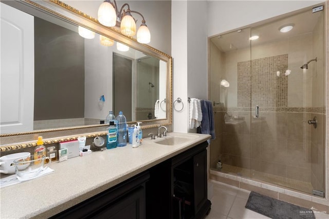 bathroom with tile patterned floors, vanity, and a shower with door