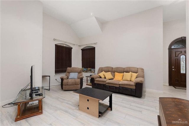 living room featuring lofted ceiling and light hardwood / wood-style flooring