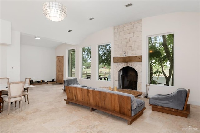 living room featuring a fireplace, plenty of natural light, and lofted ceiling