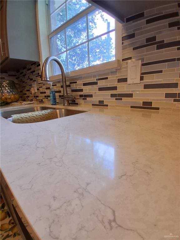 613 W Sprague St, Edinburg, TX 78539 - kitchen view of tasteful backsplash, a sink, and light stone counters