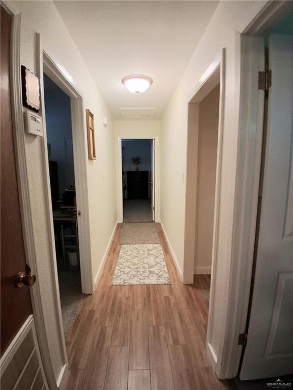 613 W Sprague St, Edinburg, TX 78539 - hall with wood finished floors and baseboards