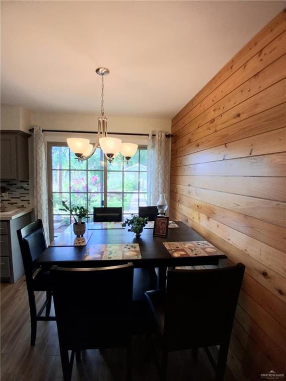 613 W Sprague St, Edinburg, TX 78539 - dining area with plenty of natural light, a chandelier, wooden walls, and wood finished floors