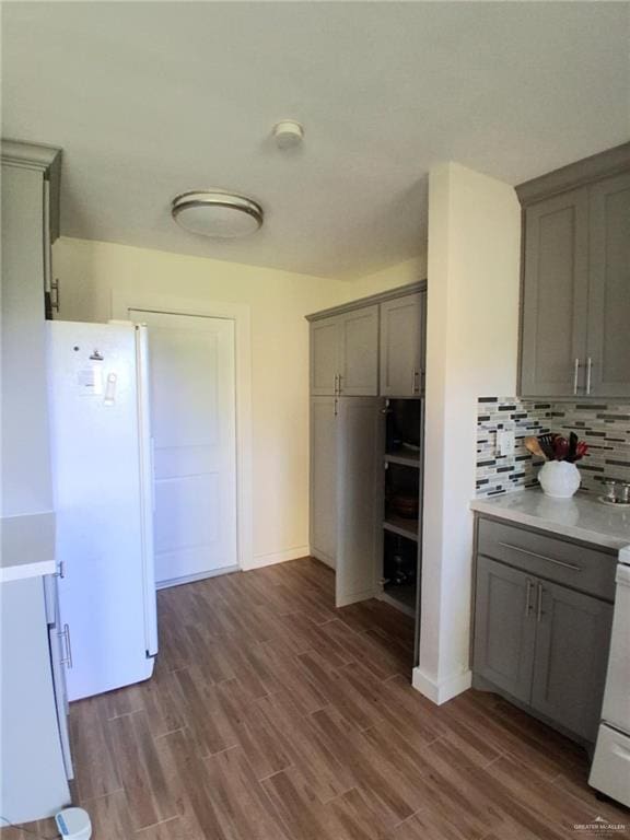 613 W Sprague St, Edinburg, TX 78539 - kitchen featuring gray cabinets, freestanding refrigerator, backsplash, and dark wood-style floors