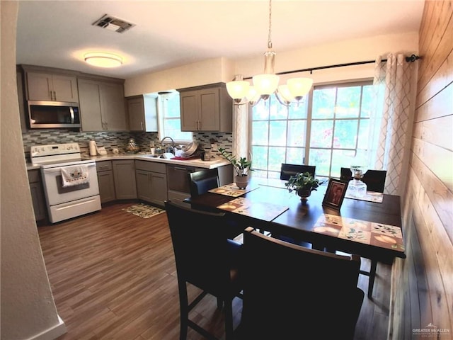 613 W Sprague St, Edinburg, TX 78539 - dining space featuring a chandelier and dark wood-style flooring