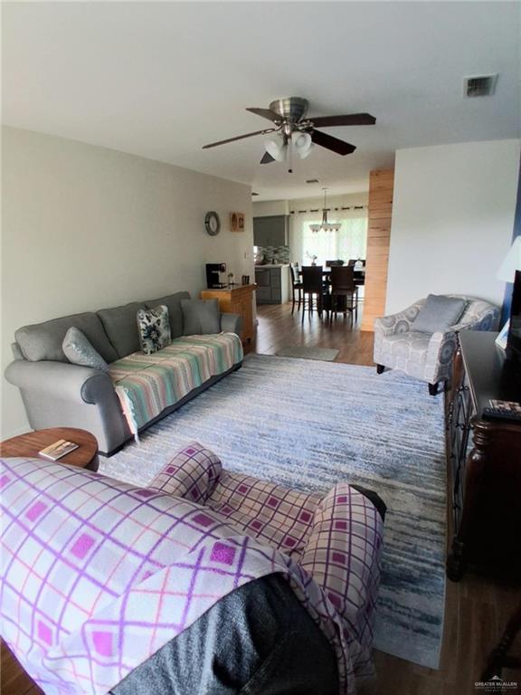 613 W Sprague St, Edinburg, TX 78539 - living area with ceiling fan and wood finished floors