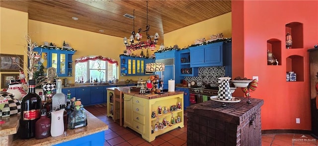 kitchen featuring dark tile patterned floors, visible vents, wooden ceiling, and a kitchen island