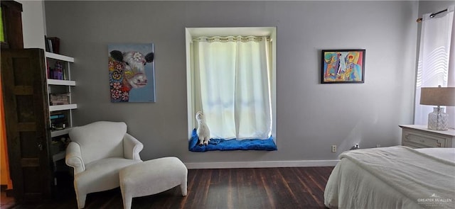 bedroom with wood finished floors and baseboards