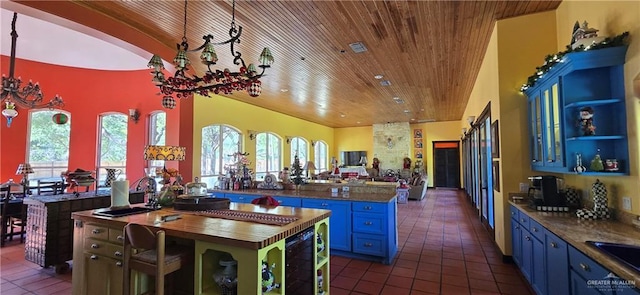 kitchen with wine cooler, open floor plan, blue cabinetry, and open shelves