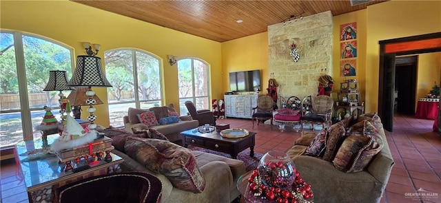 living area with tile patterned flooring, wooden ceiling, and vaulted ceiling