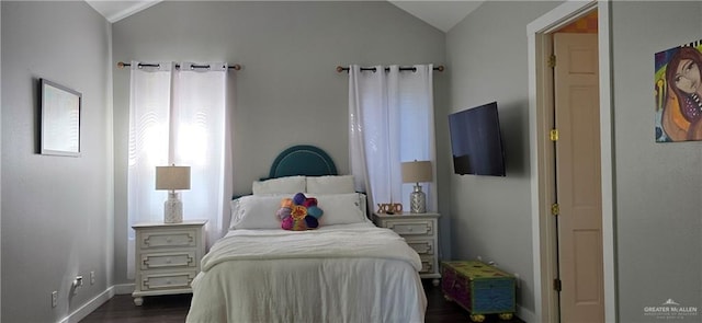 bedroom featuring baseboards, dark wood-type flooring, and lofted ceiling