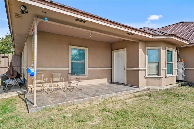 back of property featuring a yard and a patio