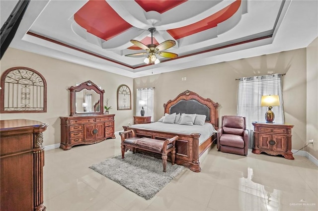 bedroom featuring multiple windows, light tile patterned floors, a raised ceiling, and ceiling fan