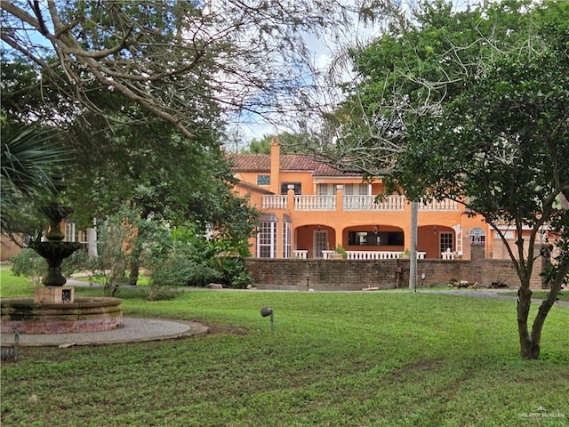 27101 N State Highway 345, San Benito, TX 78586 - rear view of property with a balcony, a yard, stucco siding, and a tiled roof