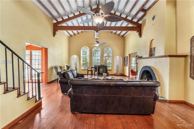 27101 N State Highway 345, San Benito, TX 78586 - living area featuring ceiling fan, beamed ceiling, wood-type flooring, stairway, and high vaulted ceiling