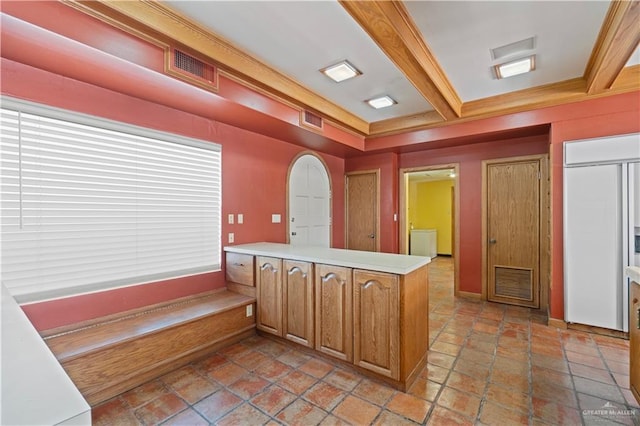 27101 N State Highway 345, San Benito, TX 78586 - kitchen with a peninsula, light countertops, paneled fridge, brown cabinets, and crown molding