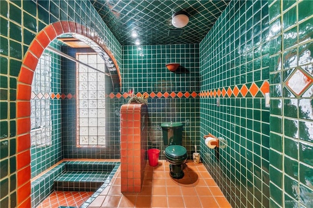 27101 N State Highway 345, San Benito, TX 78586 - bathroom featuring tile patterned floors, tile walls, and a tile shower