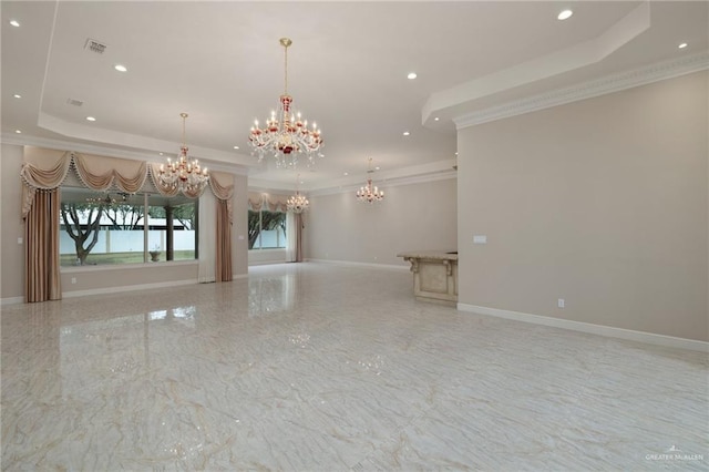 empty room with a raised ceiling, an inviting chandelier, and crown molding