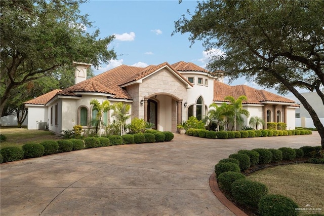 mediterranean / spanish house with a front yard