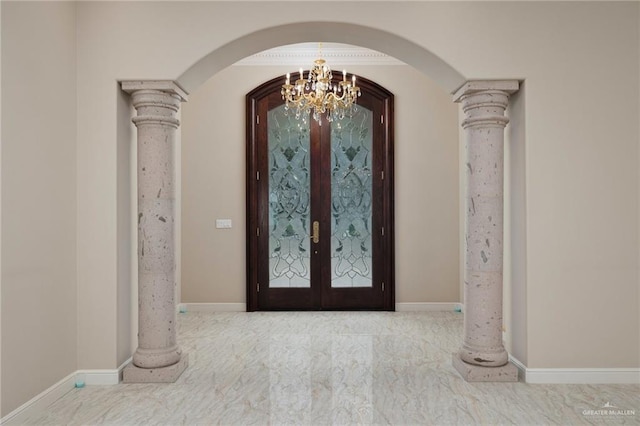 foyer entrance with french doors and a notable chandelier