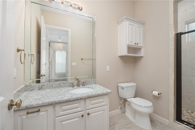 bathroom with a shower with shower door, vanity, and toilet