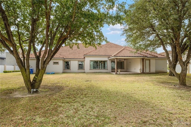 back of property featuring a lawn