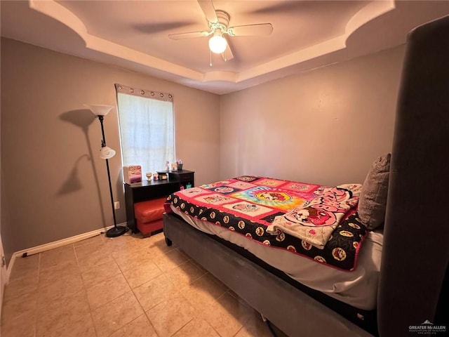 bedroom featuring a tray ceiling and ceiling fan