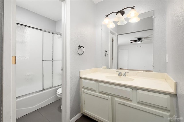 full bathroom with vanity, tile patterned floors, bath / shower combo with glass door, ceiling fan, and toilet