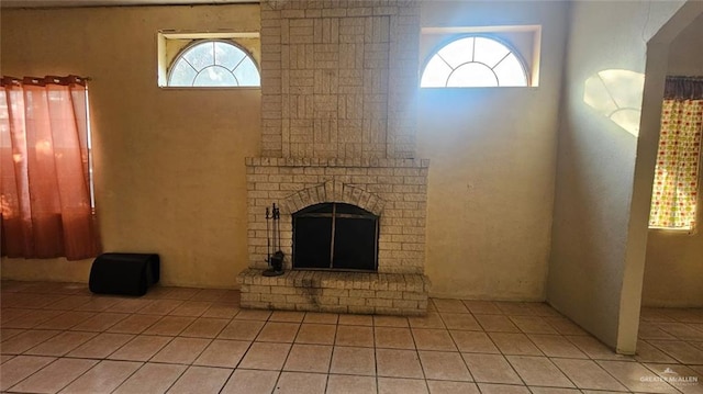 3106 E Maren Dr E, Mission, TX 78574 - unfurnished living room with light tile patterned flooring and a brick fireplace