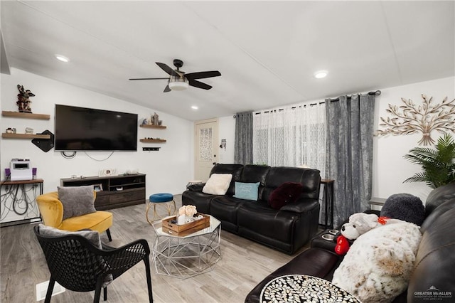 living room featuring light hardwood / wood-style flooring, ceiling fan, and lofted ceiling