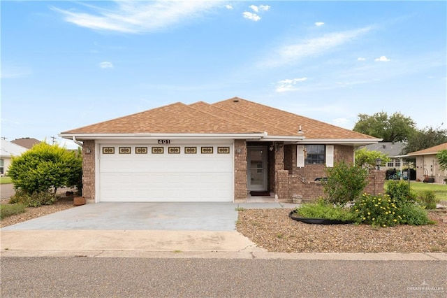 401 Taurus St, Mission, TX 78572 - ranch-style home with an attached garage, driveway, brick siding, and roof with shingles