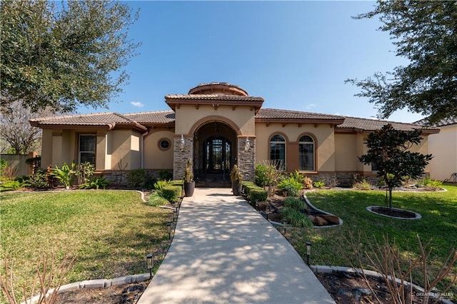 mediterranean / spanish-style home featuring a front yard