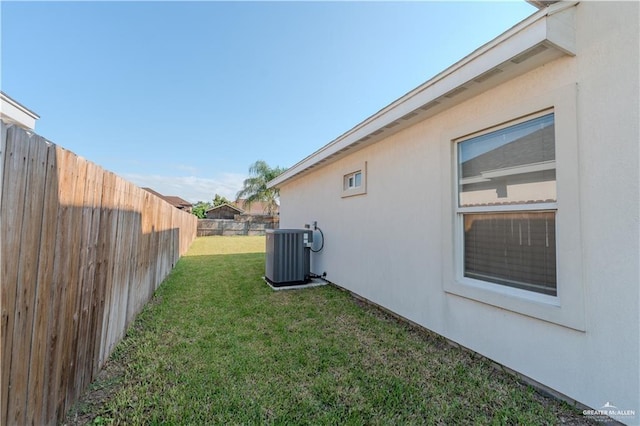 view of yard featuring a fenced backyard and central air condition unit