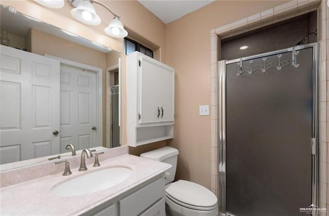 full bath with toilet, a shower stall, and vanity