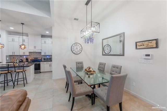 dining room with a notable chandelier, recessed lighting, visible vents, light tile patterned flooring, and baseboards