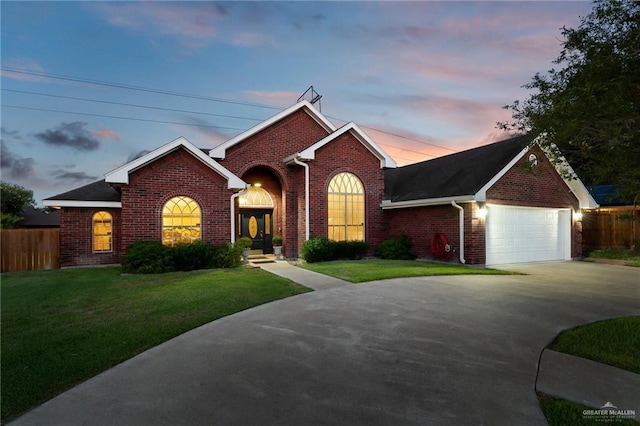 view of front of home featuring a yard and a garage