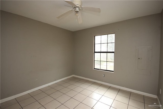 empty room featuring electric panel, ceiling fan, and light tile patterned flooring