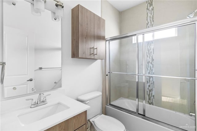 full bathroom with vanity, toilet, and combined bath / shower with glass door