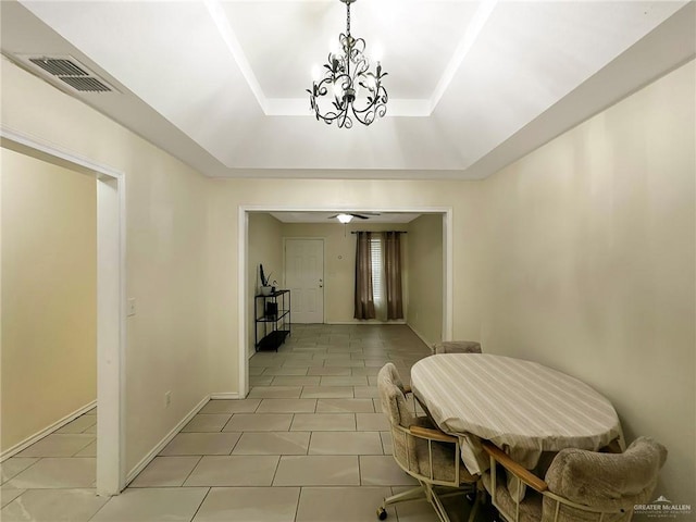 5024 Heron Ave, Mcallen, TX 78504 - dining space with light tile patterned floors, a tray ceiling, and a chandelier