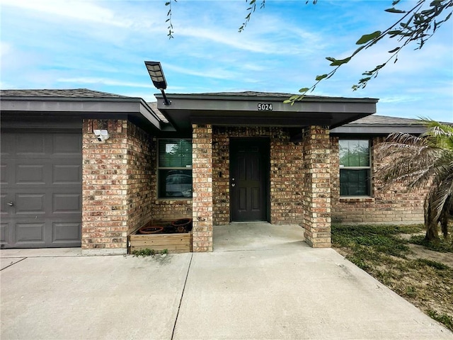 5024 Heron Ave, Mcallen, TX 78504 - entrance to property featuring brick siding and a garage